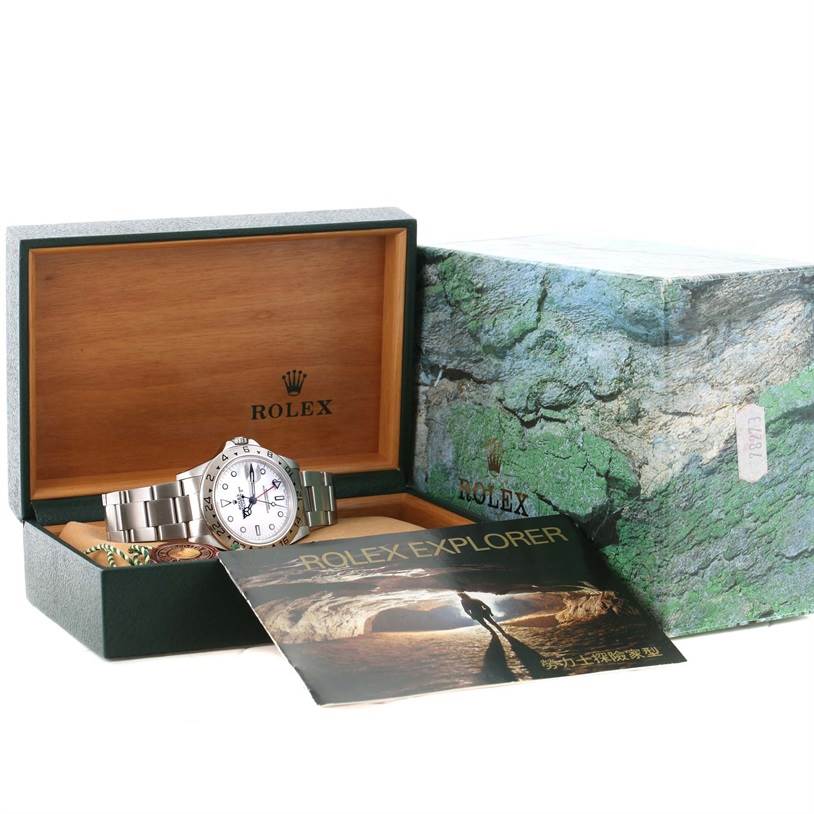 The image shows a Rolex Explorer 16570 Men's Stainless Steel White Dial 16570 Men's Stainless Steel White Dial watch displayed in its open box, alongside its outer box and an instruction booklet.
