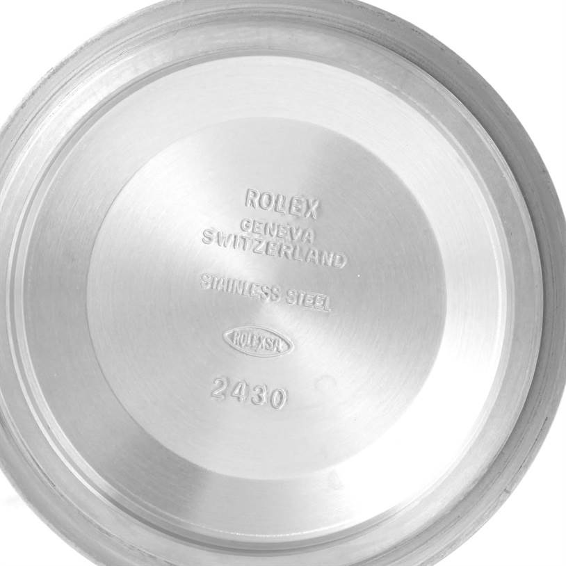 The image shows the inside case back of a Rolex Explorer 214270 Men's Stainless Steel Black Dial 214270 Men's Stainless Steel Black Dial watch, featuring brand, origin, and material markings.