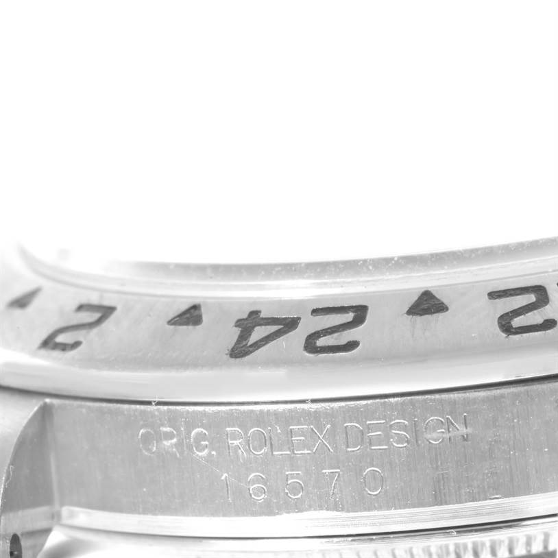 The close-up image shows the bezel and engraved case side of the Rolex Explorer 16570 Men's Stainless Steel White Dial 16570 Men's Stainless Steel White Dial model, highlighting the numbers and design details.