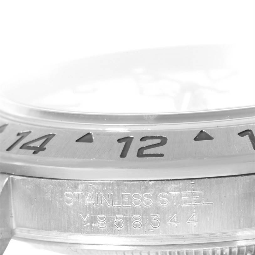 The angle shows a close-up of the bezel and case side, featuring the serial number and "STAINLESS STEEL" engraving on the Rolex Explorer 16570 Men's Stainless Steel White Dial 16570 Men's Stainless Steel White Dial.