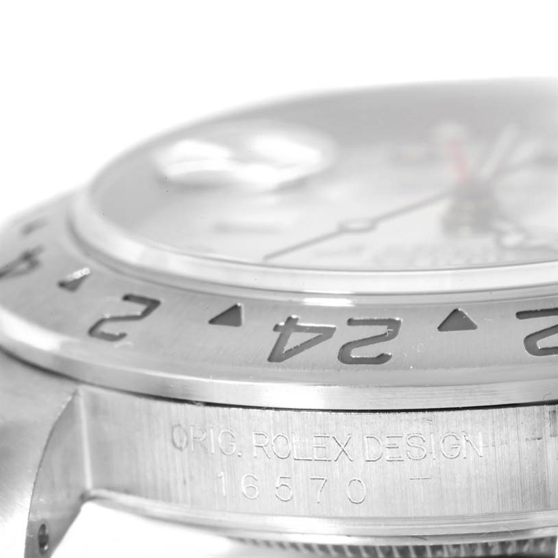 This image shows a close-up of the side and bezel of a Rolex Explorer 16570 Men's Stainless Steel White Dial 16570 Men's Stainless Steel White Dial model watch, highlighting its engraved design and markings.