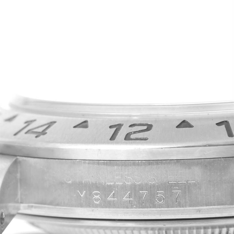 The image shows a close-up of the bezel and part of the case with engraved numbers on a Rolex Explorer 16570 Men's Stainless Steel White Dial 16570 Men's Stainless Steel White Dial model watch.