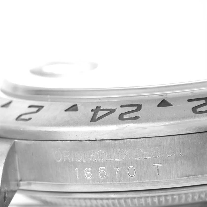 The image shows a close-up of the side and bezel of a Rolex Explorer 16570 Men's Stainless Steel White Dial 16570 Men's Stainless Steel White Dial model 16570 T, highlighting the engraved numbers and "ORIG. ROLEX DESIGN."