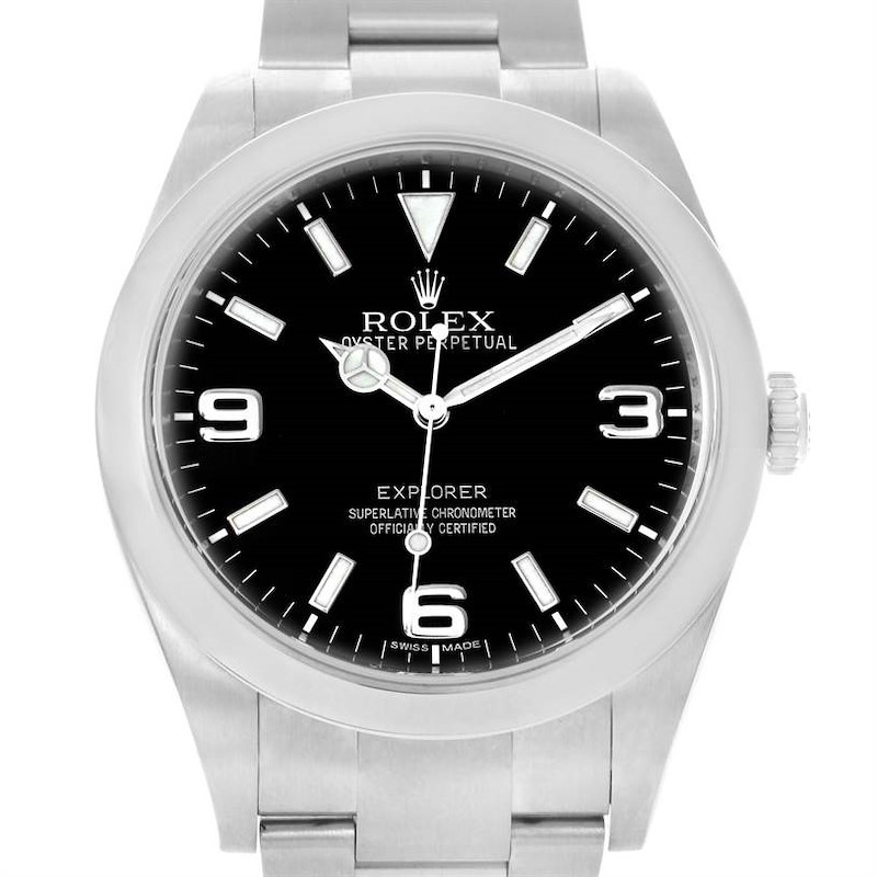 The image shows a front view of a Rolex Explorer watch, highlighting its black dial, silver bracelet, and crown.