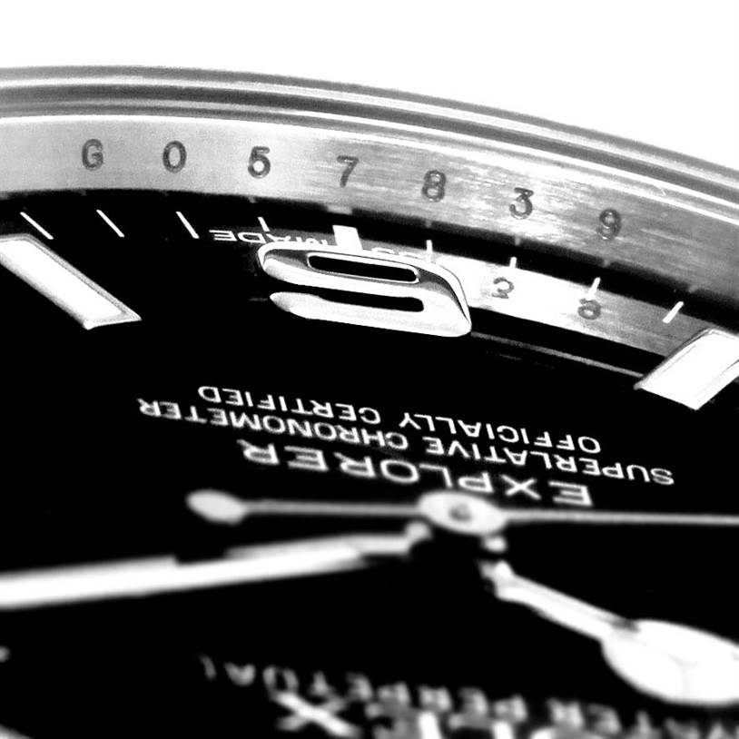 The image shows a close-up of the dial and bezel of a Rolex Explorer 214270 Men's Stainless Steel Black Dial 214270 Men's Stainless Steel Black Dial watch.