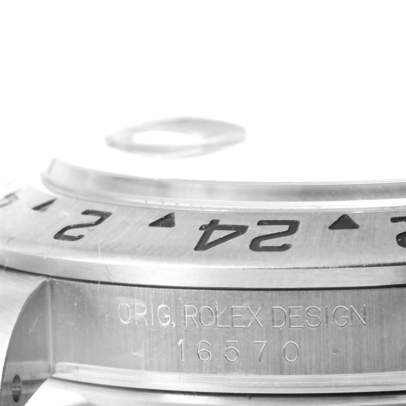 The image shows a close-up angled view of the bezel and part of the case of a Rolex Explorer 16570 Men's Stainless Steel White Dial 16570 Men's Stainless Steel White Dial model 16570.