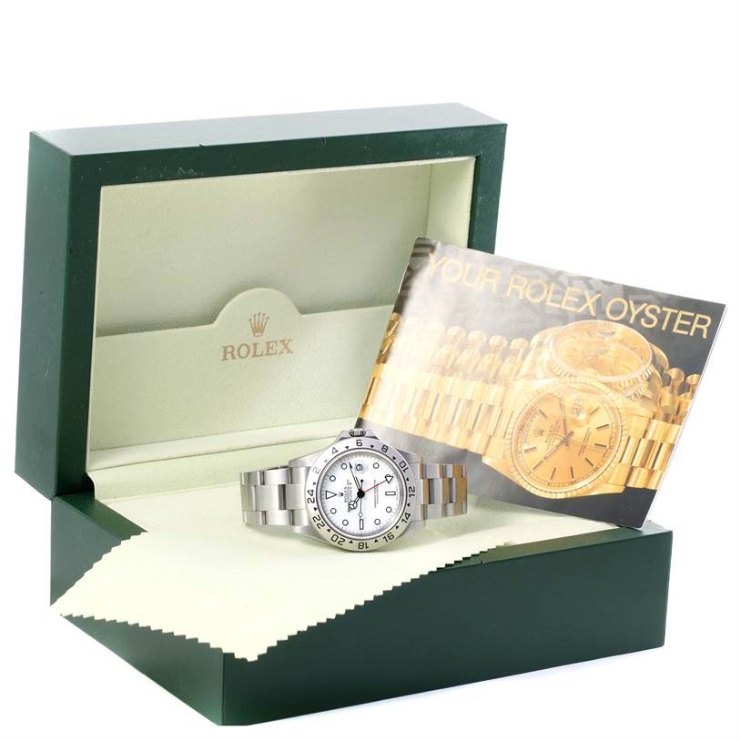 The Rolex Explorer 16570 Men's Stainless Steel White Dial 16570 Men's Stainless Steel White Dial watch is shown in its open green case with a booklet and protective cloth.
