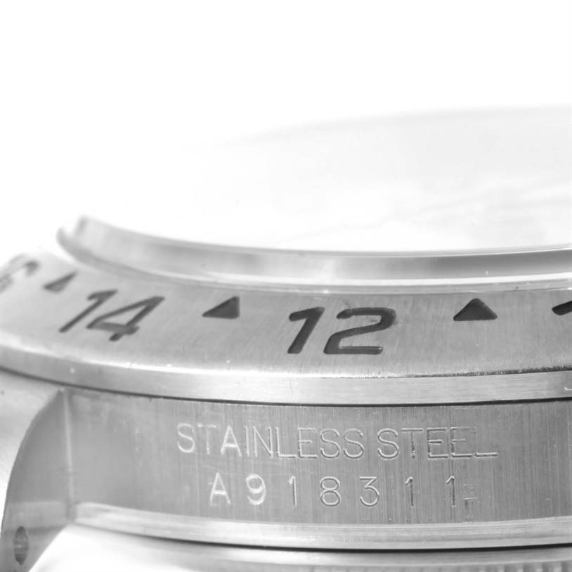 The image captures a close-up, side-angle view of the bezel and case of a stainless steel Rolex Explorer 16570 Men's Stainless Steel White Dial 16570 Men's Stainless Steel White Dial watch.