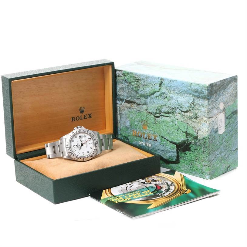 The image shows a Rolex Explorer 16570 Men's Stainless Steel White Dial 16570 Men's Stainless Steel White Dial watch inside an open green and wood presentation box, next to its outer box and a booklet.