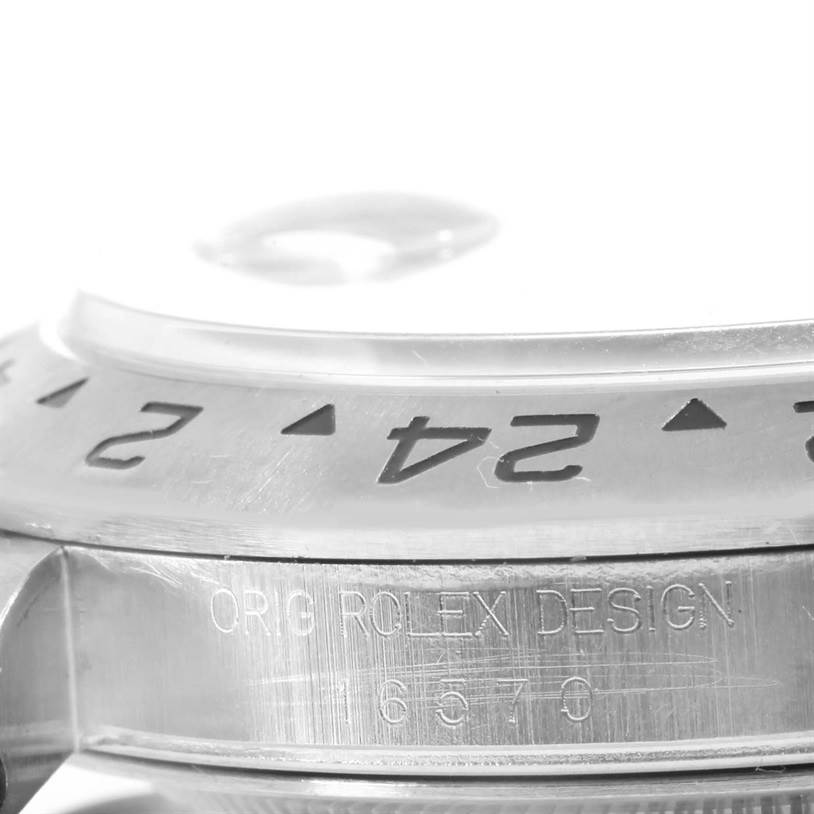 The image shows a close-up of the bezel and case side of a Rolex Explorer 16570 Men
s Stainless Steel White Dial 16570 Men
s Stainless Steel White Dial watch, highlighting the engraved text and numbering.