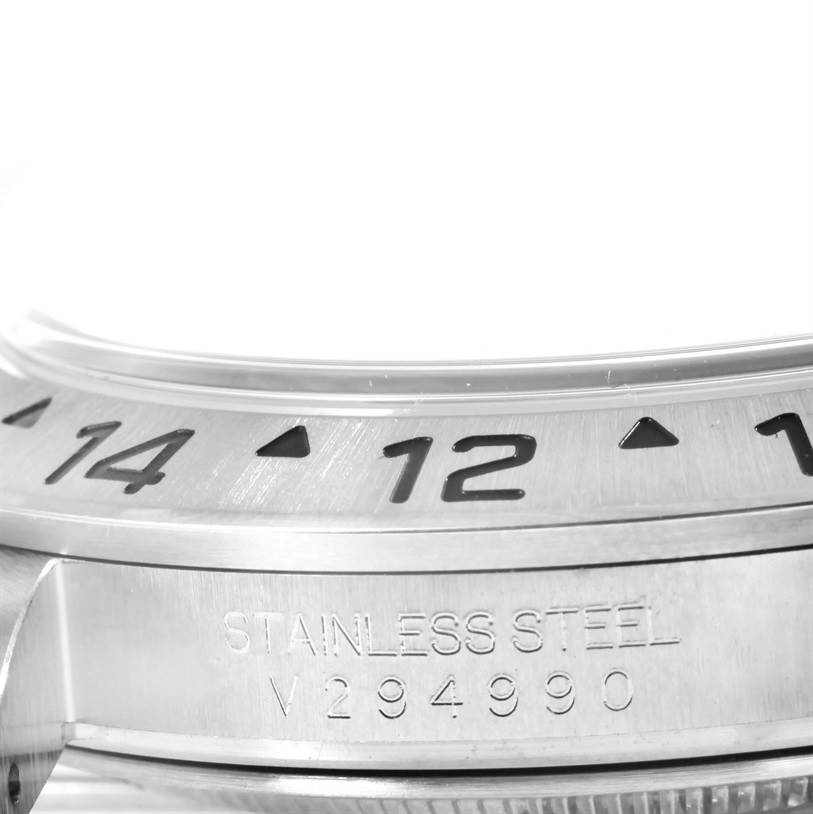 This is a close-up angle showing the bezel and part of the case of a Rolex Explorer 16570 Men's Stainless Steel Black Dial 16570 Men's Stainless Steel Black Dial watch in stainless steel.