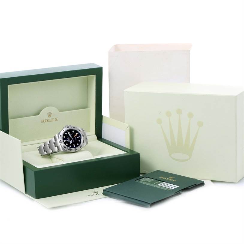 The image shows a Rolex Explorer 216570 Men
s Stainless Steel Black Dial 216570 Men
s Stainless Steel Black Dial watch in its open box, with the outer box and documentation nearby.