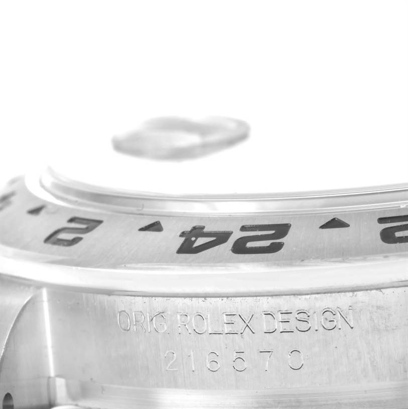 The image shows a close-up angle of the bezel and engraved side of the Rolex Explorer 216570 Men
s Stainless Steel Black Dial 216570 Men
s Stainless Steel Black Dial watch model 216570.