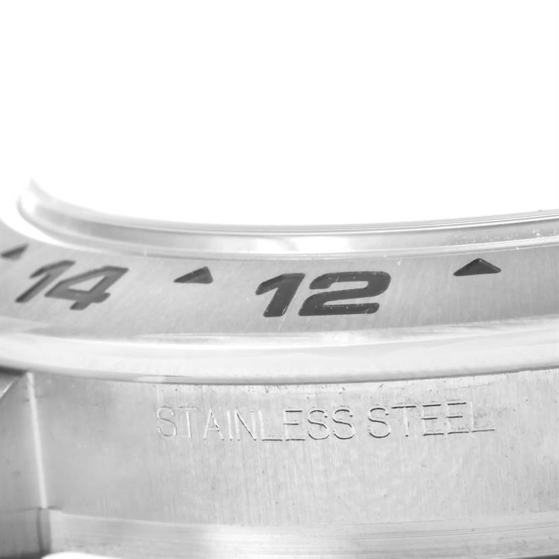 This close-up image of the Rolex Explorer 216570 Men
s Stainless Steel Black Dial 216570 Men
s Stainless Steel Black Dial watch showcases part of its stainless steel bezel with the numbers 14 and 12 visible.