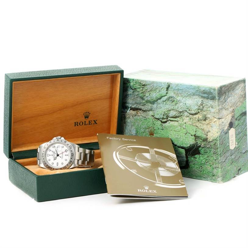 The Rolex Explorer 16570 Men's Stainless Steel White Dial 16570 Men's Stainless Steel White Dial watch is shown at an angle displaying its face and bracelet, along with its open wooden box and service booklet.