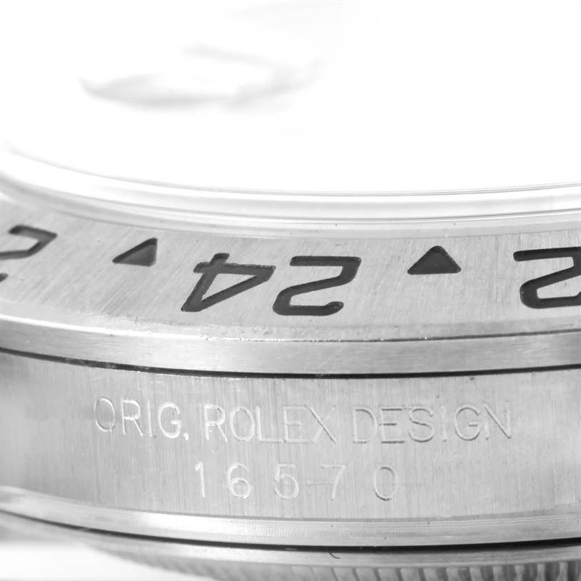 Close-up of the stainless steel bezel and case side of a Rolex Explorer 16570 Men's Stainless Steel White Dial 16570 Men's Stainless Steel White Dial, showing engraved numbers and "ORIG. ROLEX DESIGN 16570."