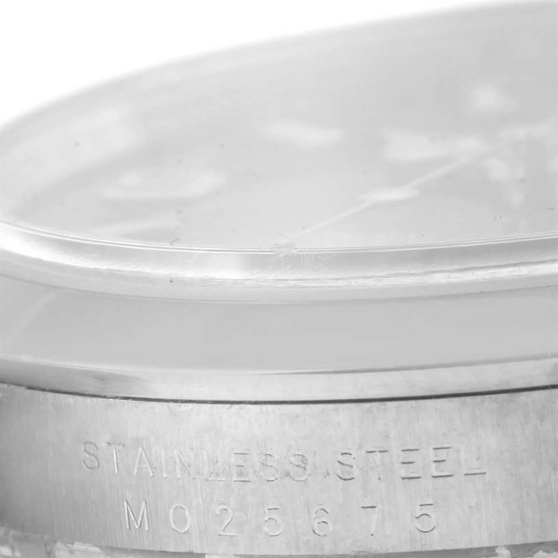 This image shows a close-up of the side of a Rolex Explorer 114270 Men's Stainless Steel Black Dial 114270 Men's Stainless Steel Black Dial watch, highlighting its stainless steel case and serial number.