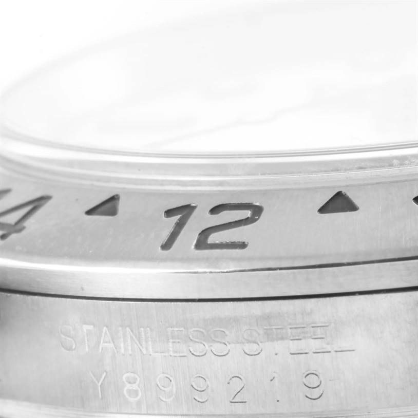 The image shows a close-up of the bezel and serial number engraving of a Rolex Explorer 16570 Men's Stainless Steel White Dial 16570 Men's Stainless Steel White Dial watch.