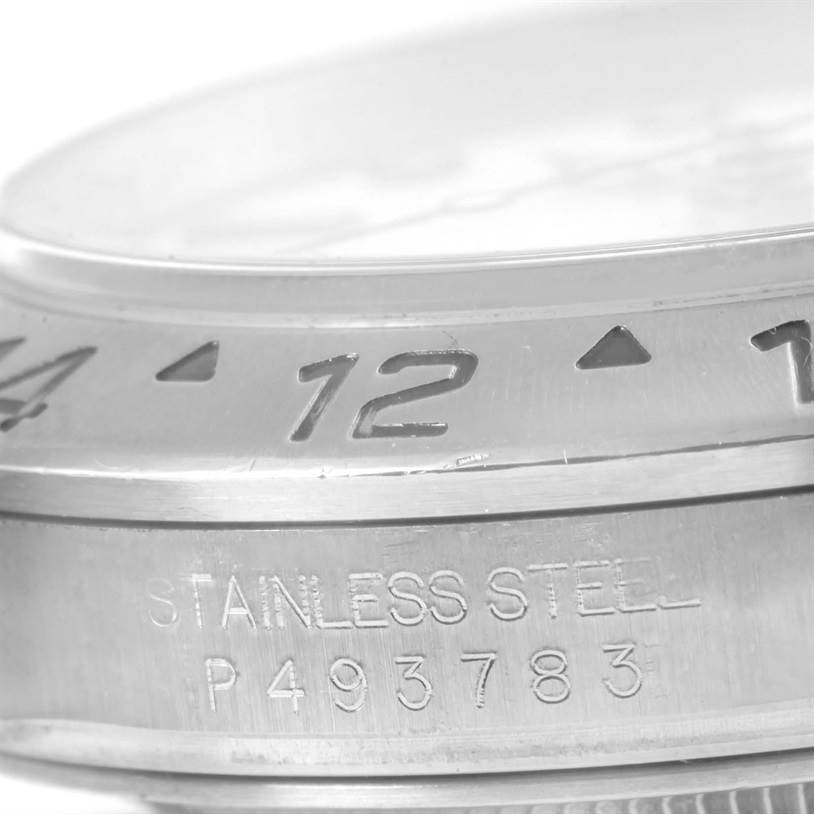 This image shows a close-up of the bezel and case of a Rolex Explorer 16570 Men's Stainless Steel White Dial 16570 Men's Stainless Steel White Dial watch, highlighting the stainless steel engravings.