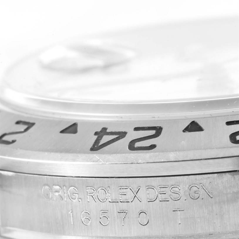 Close-up of the side view of the Rolex Explorer 16570 Men's Stainless Steel White Dial 16570 Men's Stainless Steel White Dial model, showing engraved details and partial bezel with numerals.