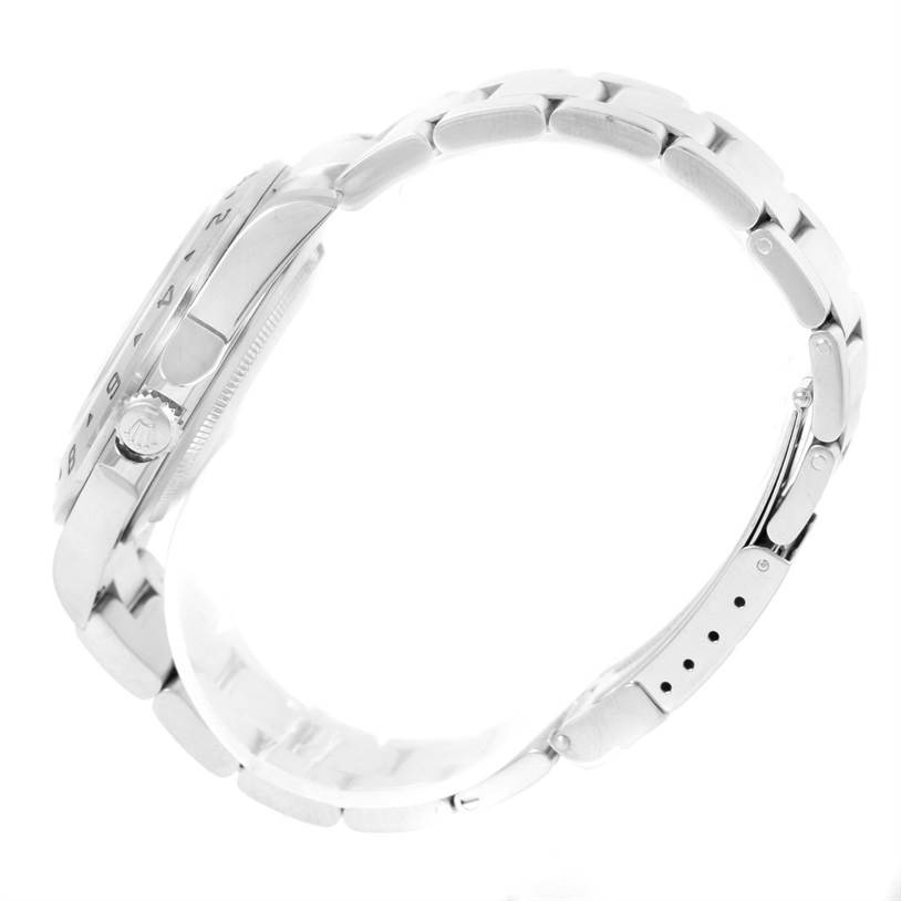 This side view of the Rolex Explorer 16570 Men's Stainless Steel White Dial 16570 Men's Stainless Steel White Dial watch shows the case, crown, and bracelet with clasp extended.