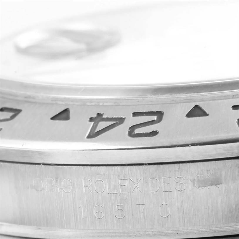 The image shows a close-up angle of the bezel and case side of a Rolex Explorer 16570 Men's Stainless Steel White Dial 16570 Men's Stainless Steel White Dial watch, with model number 16570 engraved.