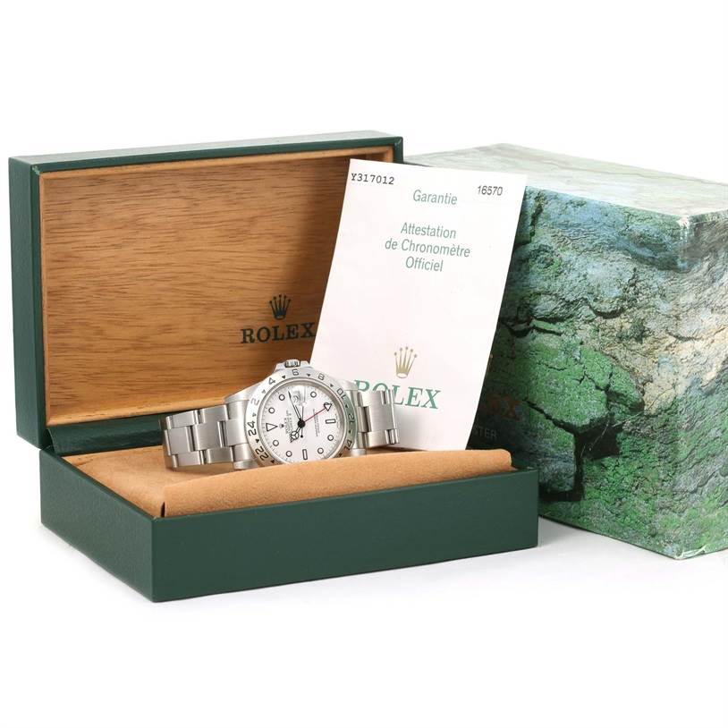 The Rolex Explorer 16570 Men's Stainless Steel White Dial 16570 Men's Stainless Steel White Dial watch is shown front-facing in its box, alongside its warranty card and packaging.