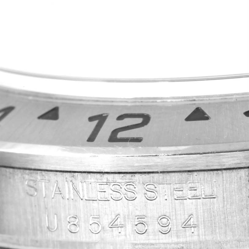 This close-up image shows the bezel and serial engraving on the side of a Rolex Explorer 16570 Men's Stainless Steel White Dial 16570 Men's Stainless Steel White Dial watch.