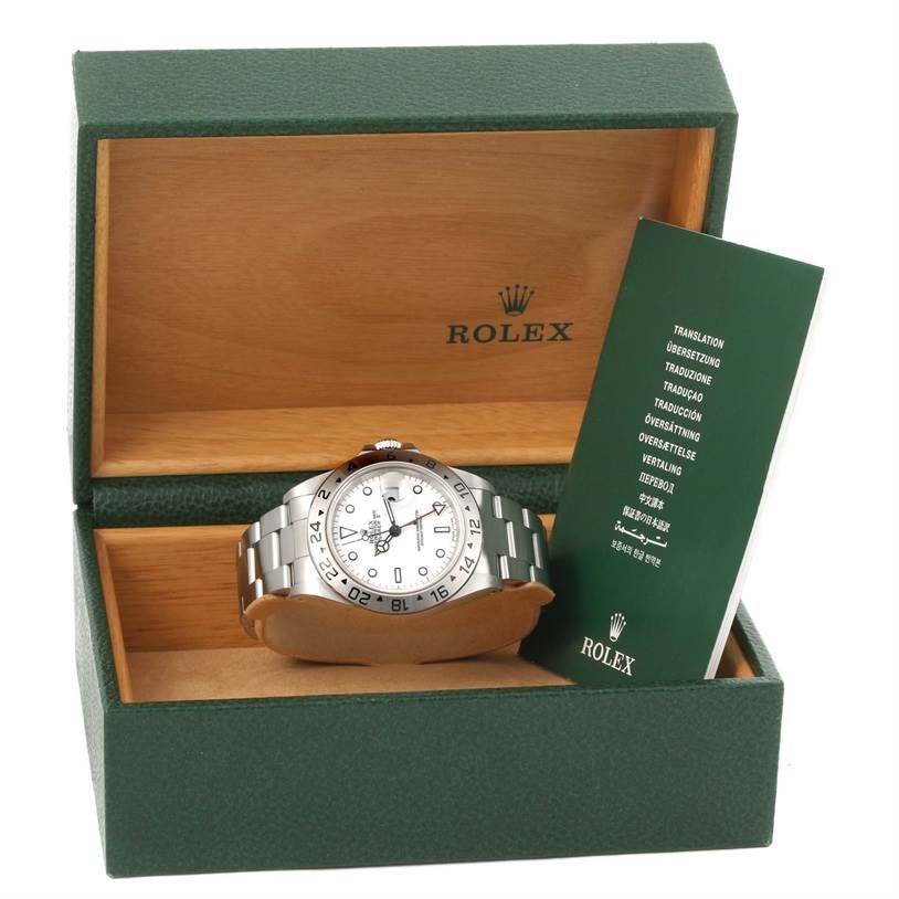 The image displays a Rolex Explorer 16570 Men's Stainless Steel White Dial 16570 Men's Stainless Steel White Dial watch in its open box, showing the face, strap, and documentation.