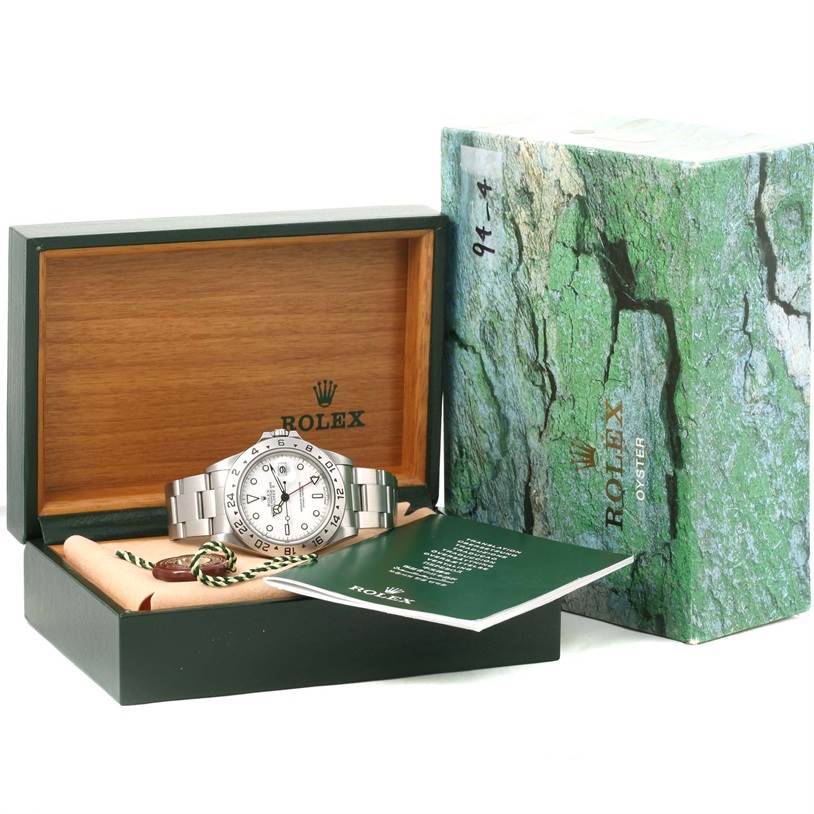 This image shows a Rolex Explorer 16570 Men's Stainless Steel White Dial 16570 Men's Stainless Steel White Dial watch at a front angle, in its open box with accessories including a manual and tags.