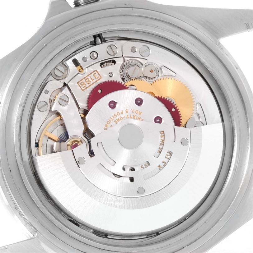 The image shows a close-up view of the movement mechanism inside the Rolex Explorer 16570 Men's Stainless Steel Black Dial 16570 Men's Stainless Steel Black Dial watch, highlighting gears and intricate components.