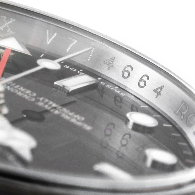 The image shows a close-up angled view of the Rolex Explorer 16570 Men's Stainless Steel Black Dial 16570 Men's Stainless Steel Black Dial watch's face and etched case details.