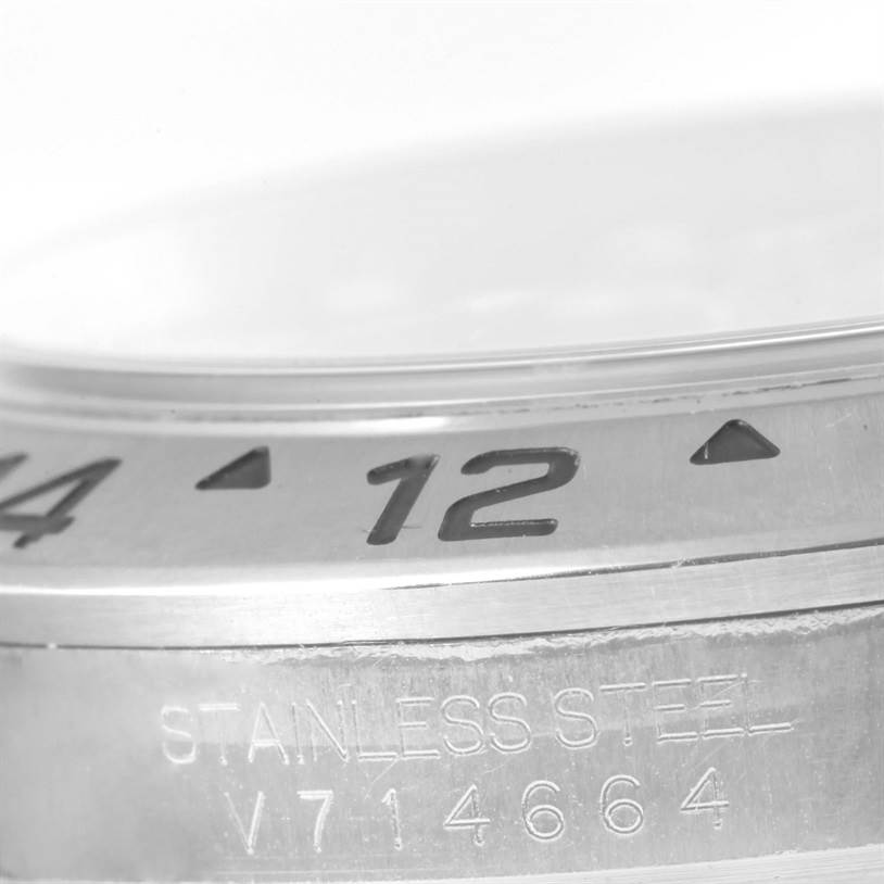 The image shows a close-up angle of a Rolex Explorer 16570 Men's Stainless Steel Black Dial 16570 Men's Stainless Steel Black Dial model watch, highlighting the bezel and part of the case with "Stainless Steel" engraved.