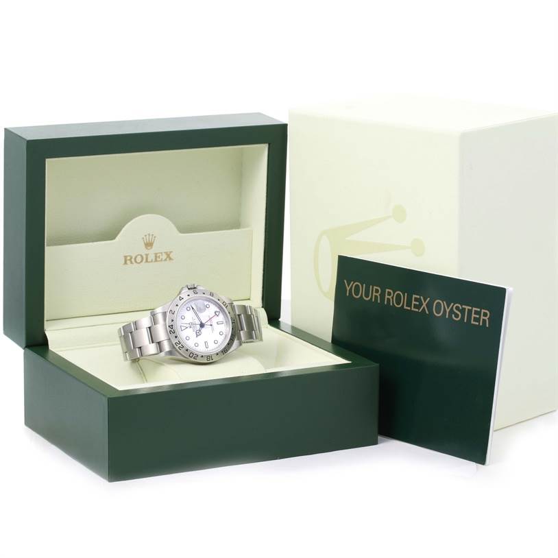 The Rolex Explorer 16570 Men's Stainless Steel White Dial 16570 Men's Stainless Steel White Dial watch is shown in its open box with a booklet, from a frontal angle.