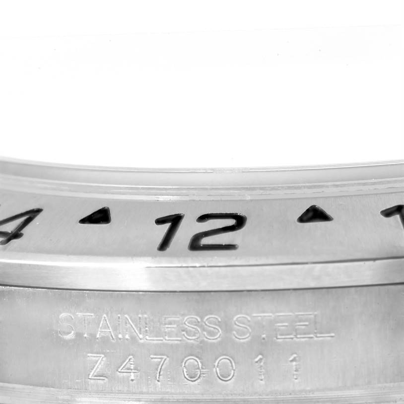 This image shows a close-up of the bezel and stainless steel casing of a Rolex Explorer 16570 Men's Stainless Steel White Dial 16570 Men's Stainless Steel White Dial watch, highlighting the serial number.