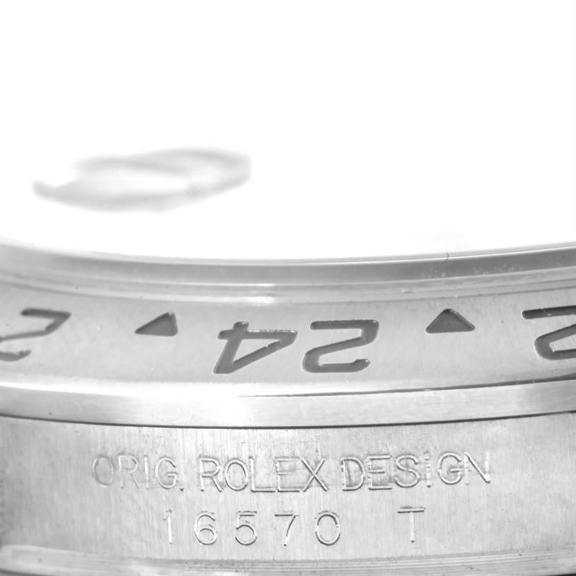 Close-up of the case edge showing the "ORIG. ROLEX DESIGN" engraving and part of the bezel on a Rolex Explorer 16570 Men's Stainless Steel White Dial 16570 Men's Stainless Steel White Dial model 16570.