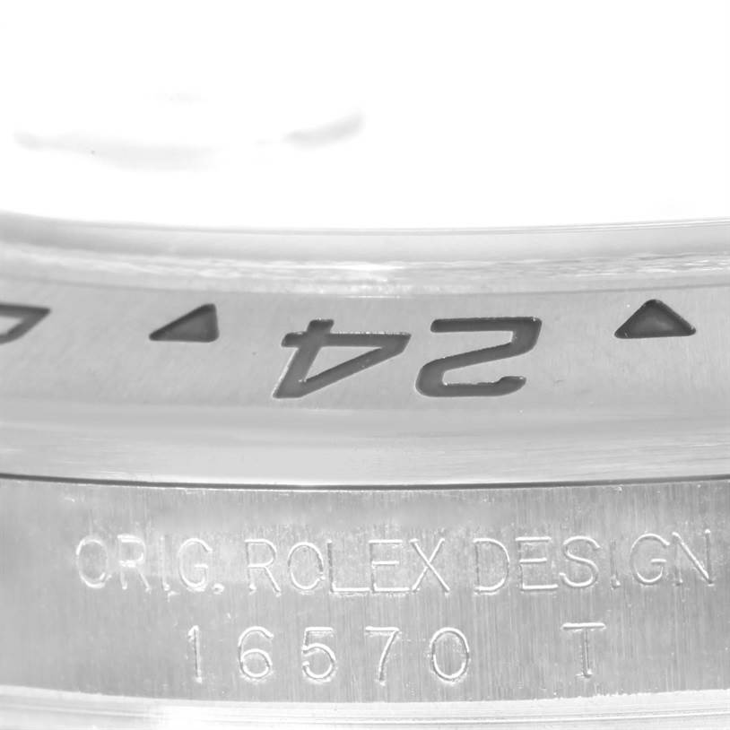 This close-up image shows the bezel and engraved inner part of a Rolex Explorer 16570 Men's Stainless Steel White Dial 16570 Men's Stainless Steel White Dial model 16570 watch.