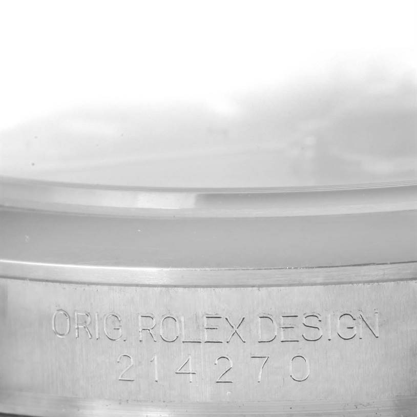 This image shows a close-up of the case side of a Rolex Explorer 214270 Men's Stainless Steel Black Dial 214270 Men's Stainless Steel Black Dial, highlighting the "ORIG. ROLEX DESIGN 214270" engraving.