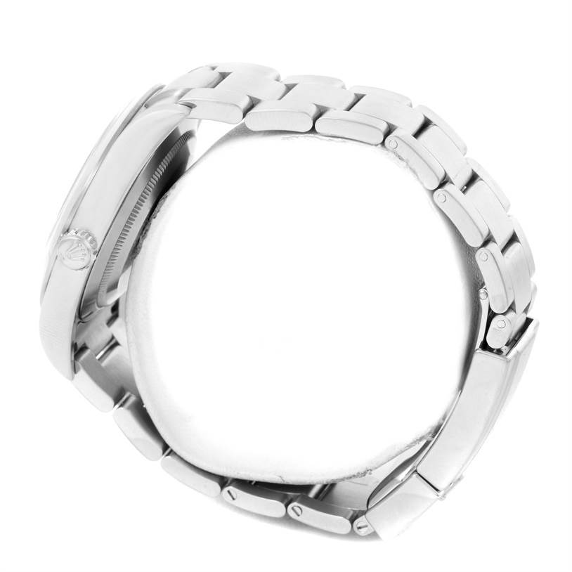 This side view of the Rolex Explorer 214270 Men's Stainless Steel Black Dial 214270 Men's Stainless Steel Black Dial watch shows the crown, case, and bracelet links.