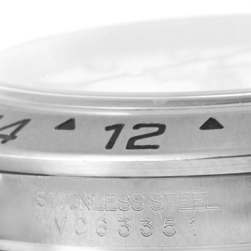 The image shows a close-up of the bezel and part of the casing with the serial number of a Rolex Explorer 16570 Men's Stainless Steel White Dial 16570 Men's Stainless Steel White Dial watch.