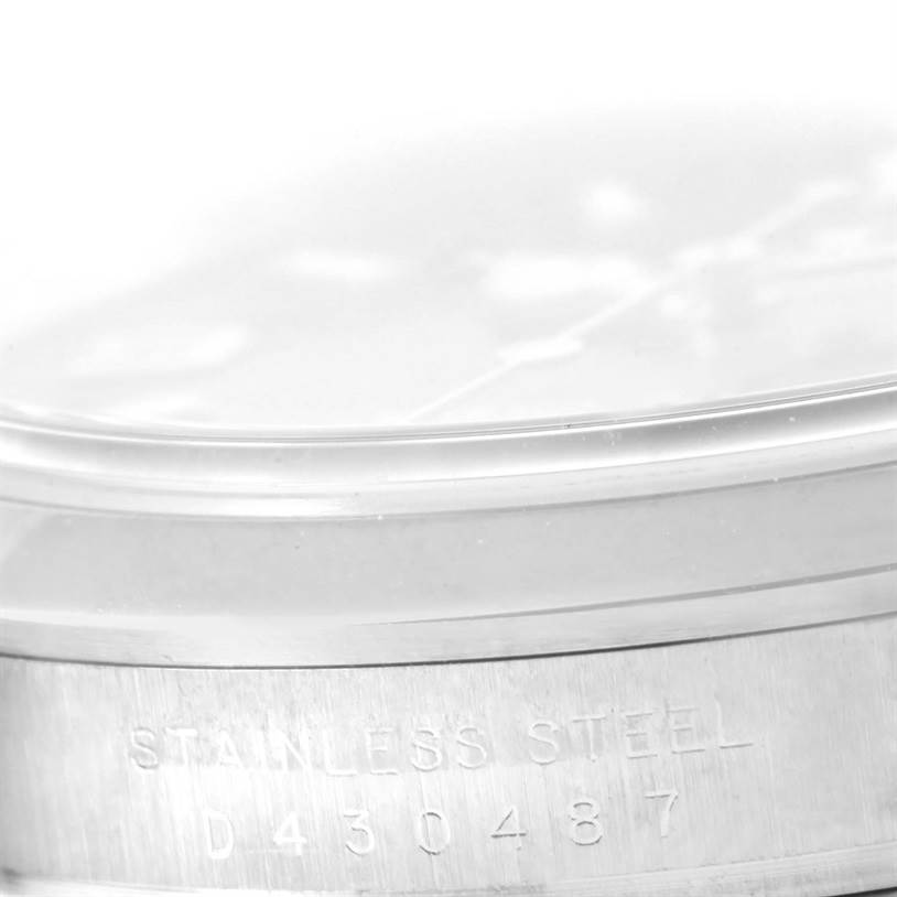 The image shows a close-up of the stainless steel case back of a Rolex Explorer 114270 Men's Stainless Steel Black Dial 114270 Men's Stainless Steel Black Dial watch, including its serial number.