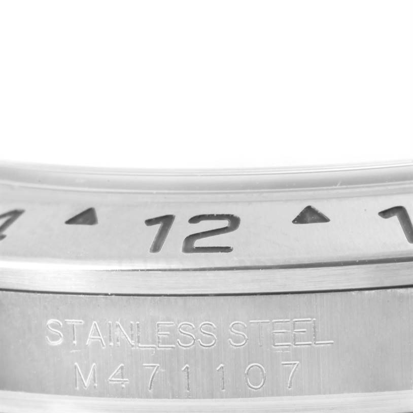 The image shows a close-up of the stainless steel bezel and part of the casing for a Rolex Explorer 16570 Men's Stainless Steel Black Dial 16570 Men's Stainless Steel Black Dial watch.