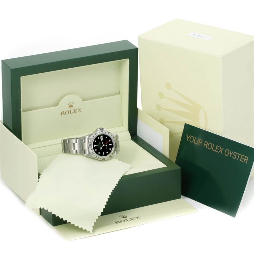 The image shows a Rolex Explorer 16570 Men's Stainless Steel Black Dial 16570 Men's Stainless Steel Black Dial watch in its open box with a cleaning cloth and accompanying booklet.