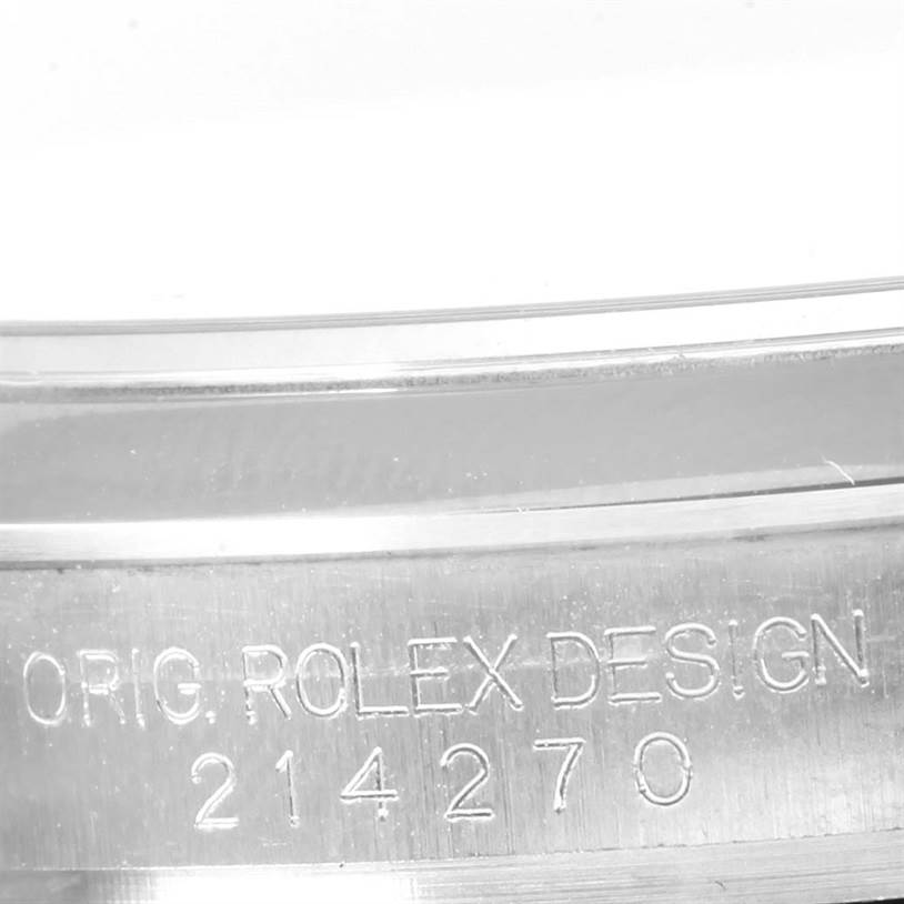 The image shows a close-up of the inner engraving on the Rolex Explorer 214270 Men's Stainless Steel Black Dial 214270 Men's Stainless Steel Black Dial model, displaying "Orig. Rolex Design 214270".