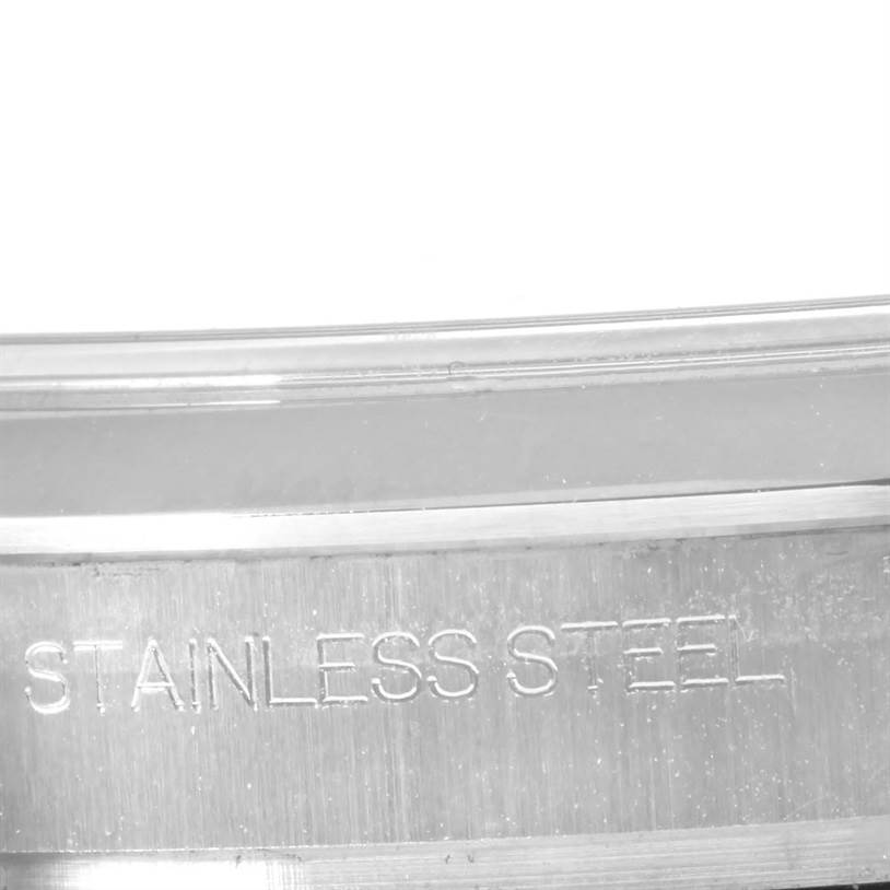 This image shows a close-up view of the "Stainless Steel" engraving on the casing of a Rolex Explorer 214270 Men's Stainless Steel Black Dial 214270 Men's Stainless Steel Black Dial model watch.