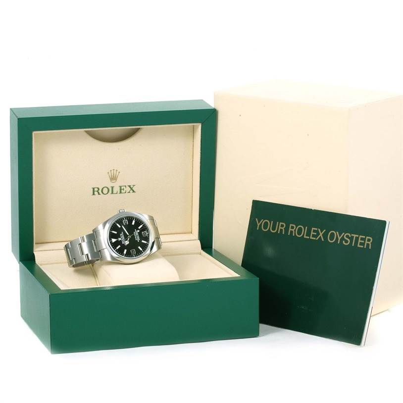 The image shows the Rolex Explorer 214270 Men's Stainless Steel Black Dial 214270 Men's Stainless Steel Black Dial watch in its open green and cream box, alongside the "Your Rolex Oyster" booklet.