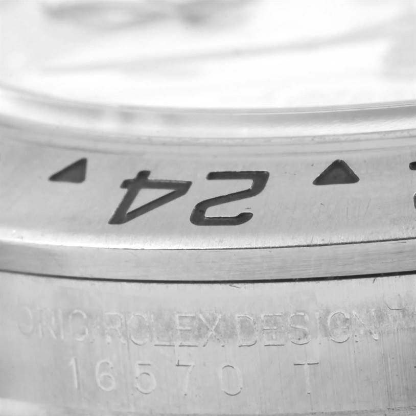 The image shows a close-up of the bezel and part of the case with model number engraving on a Rolex Explorer 16570 Men's Stainless Steel White Dial 16570 Men's Stainless Steel White Dial watch.