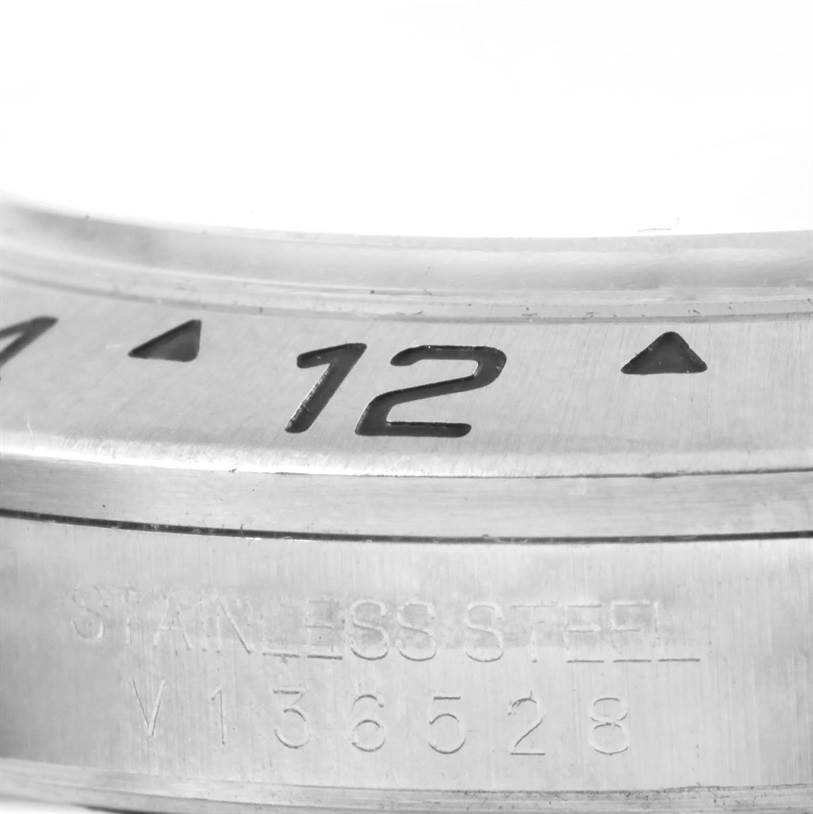 Close-up image of the bezel and side engraving of a Rolex Explorer 16570 Men's Stainless Steel White Dial 16570 Men's Stainless Steel White Dial watch, showing the number "12" and "stainless steel" text.