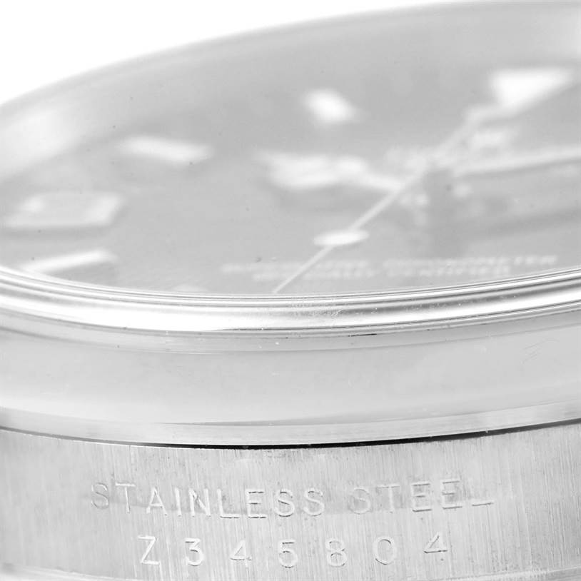 The image shows a close-up side view of a Rolex Explorer 114270 Men
s Stainless Steel Black Dial 114270 Men
s Stainless Steel Black Dial watch highlighting the stainless steel case and part of the dial.