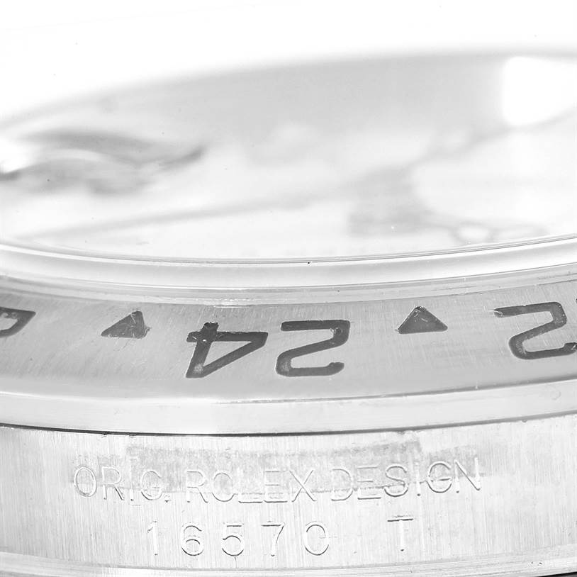 This image shows the side view of a Rolex Explorer 16570 Men's Stainless Steel White Dial 16570 Men's Stainless Steel White Dial with emphasis on the bezel and engraved model number 16570 T.
